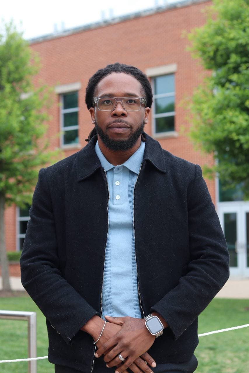 Mathias Fobi, co-founder of Keldya, photographed on a university campus in a black jacket and light blue polo